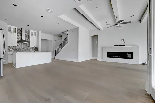 a view of a livingroom with fireplace and a ceiling fan