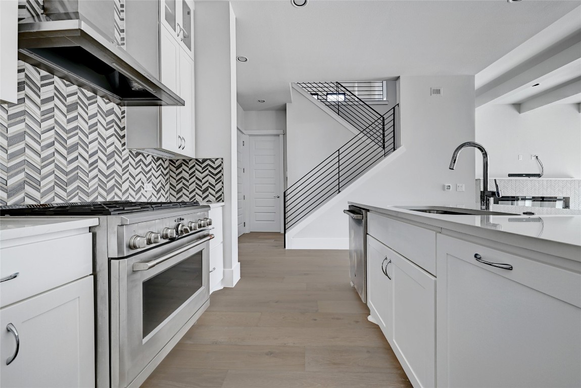 1815 West 38th Street Austin, TX 78731 - Photo 8 of 25 a kitchen with white cabinets and appliances
