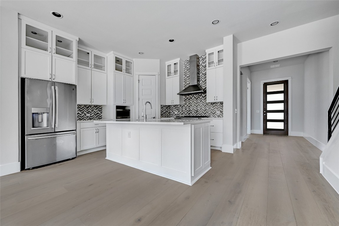 1815 West 38th Street Austin, TX 78731 - Photo 9 of 25 a kitchen with white cabinets and stainless steel appliances