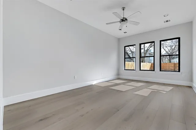 wooden floor in an empty room with a window