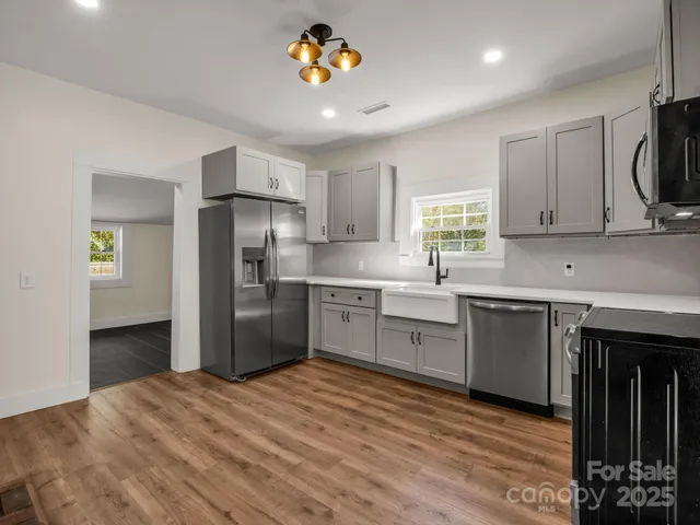 a kitchen with a refrigerator sink and cabinets