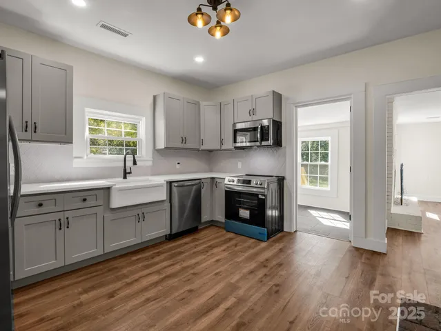 a kitchen with a stove a sink and a microwave