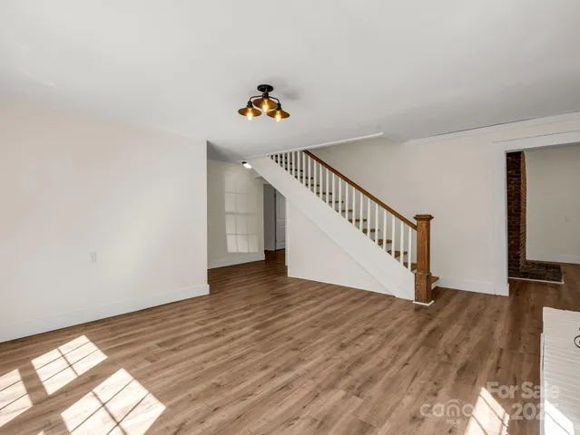 a view of an entryway with wooden floor