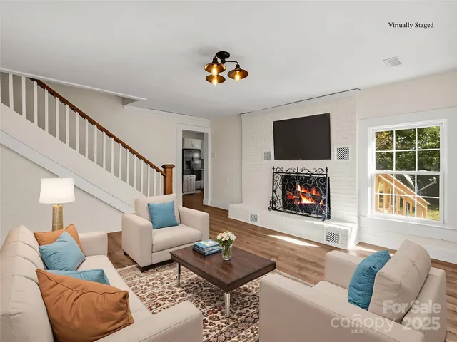 a living room with furniture and a fireplace