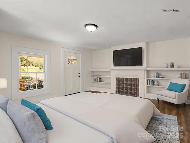 a bedroom with a bed and a television