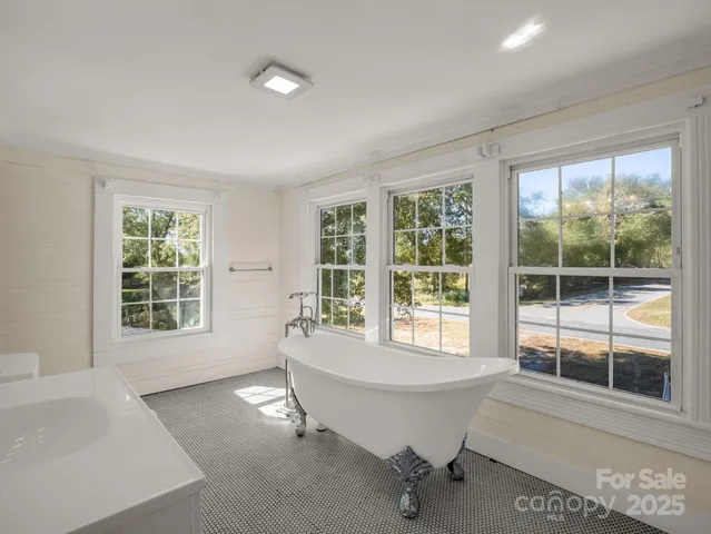 a bathroom with a bathtub and windows