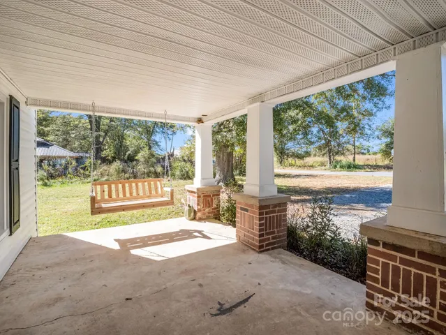 a bedroom with furniture and large windows