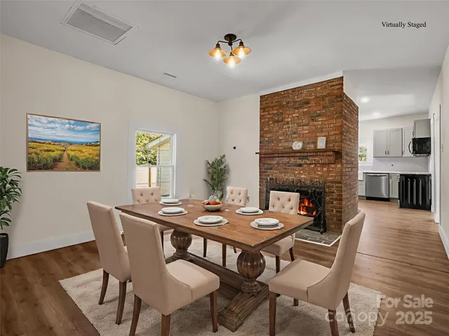 a dining room with furniture window and wooden floor