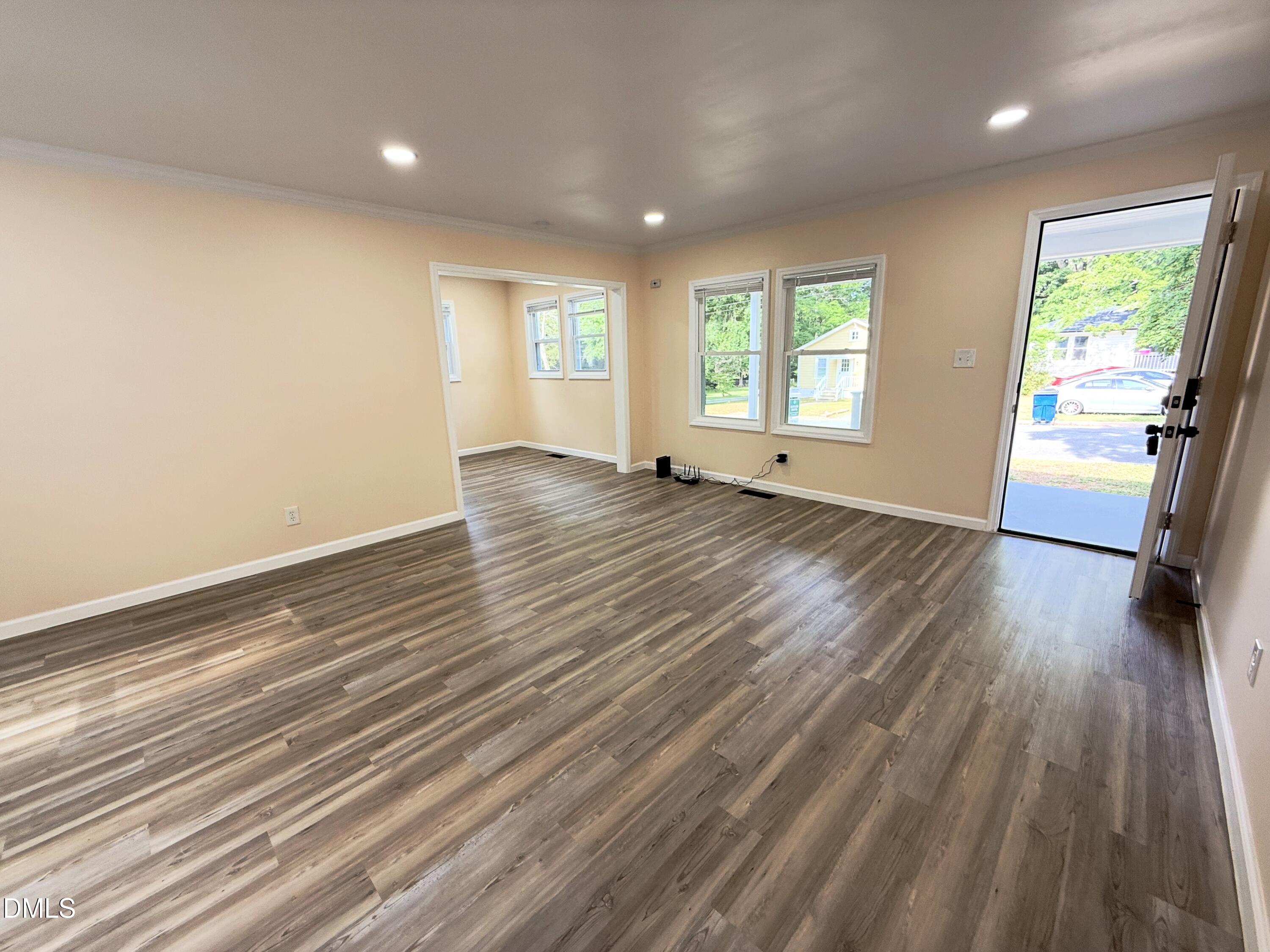 417 North Street Graham, NC 27253 - Photo 11 of 18 an empty room with wooden floor and windows