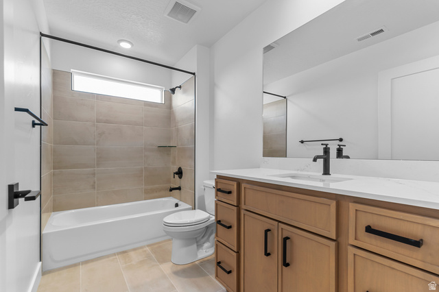 1341 West 2350 South, Unit 10 Perry, UT 84302 - Photo 15 of 18 Contemporary bathroom featuring a light wood-finish vanity with a white countertop and undermount sink, matte black fixtures, an expansive mirror, and a tiled tub/shower combination with a transom window