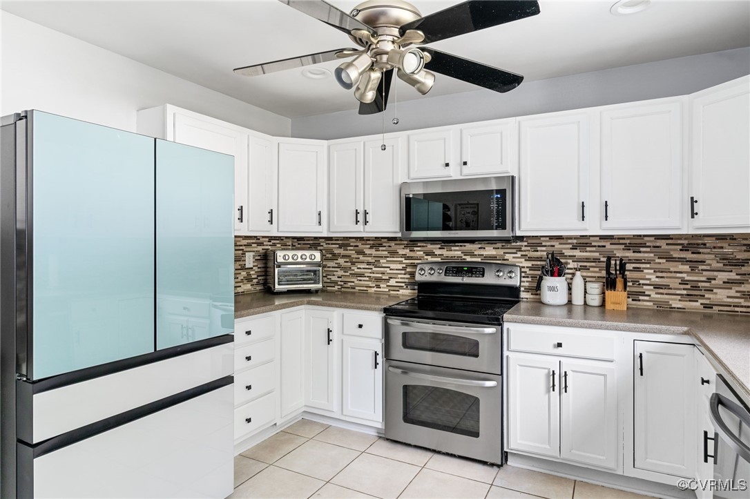 119 Monath Road Richmond, VA 23236 - Photo 8 of 48 a kitchen with white cabinets stainless steel appliances and a counter space