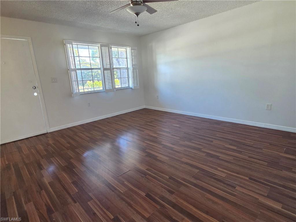 3325 Airport Road North, Unit G7 Naples, FL 34105 - Photo 3 of 13 wooden floor in an empty room with a window