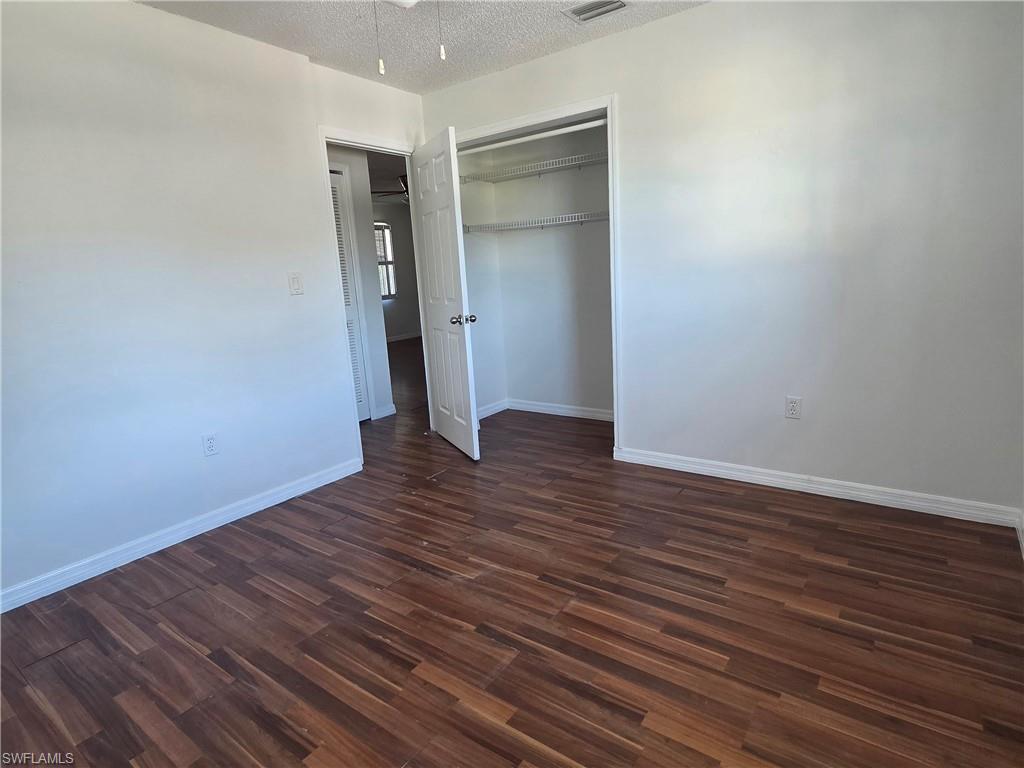 3325 Airport Road North, Unit G7 Naples, FL 34105 - Photo 6 of 13 a view of an empty room with wooden floor and closet