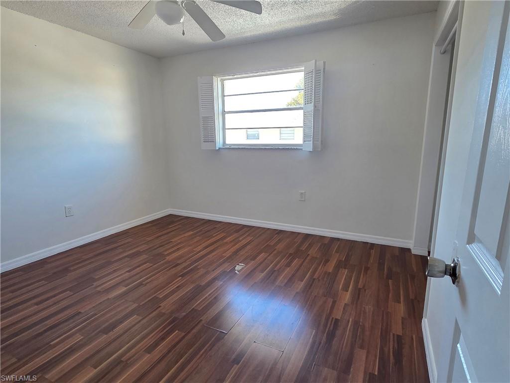 3325 Airport Road North, Unit G7 Naples, FL 34105 - Photo 7 of 13 an empty room with wooden floor and windows