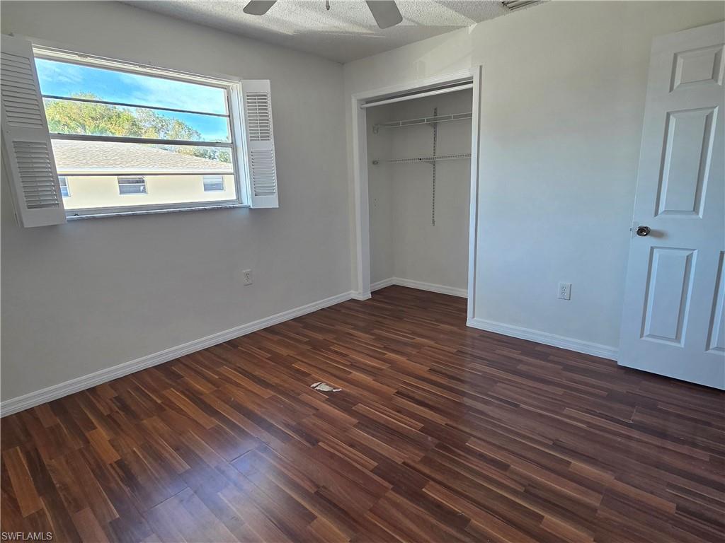 3325 Airport Road North, Unit G7 Naples, FL 34105 - Photo 8 of 13 an empty room with wooden floor and windows