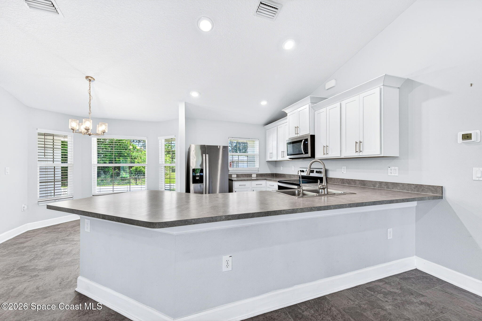717 Gelaso Street Southwest Palm Bay, FL 32908 - Photo 14 of 48 a kitchen with stainless steel appliances granite countertop a sink a stove and a granite counter top