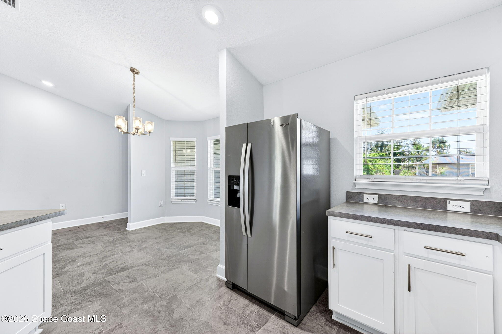 717 Gelaso Street Southwest Palm Bay, FL 32908 - Photo 15 of 48 a kitchen with stainless steel appliances granite countertop a refrigerator a sink and a granite counter tops