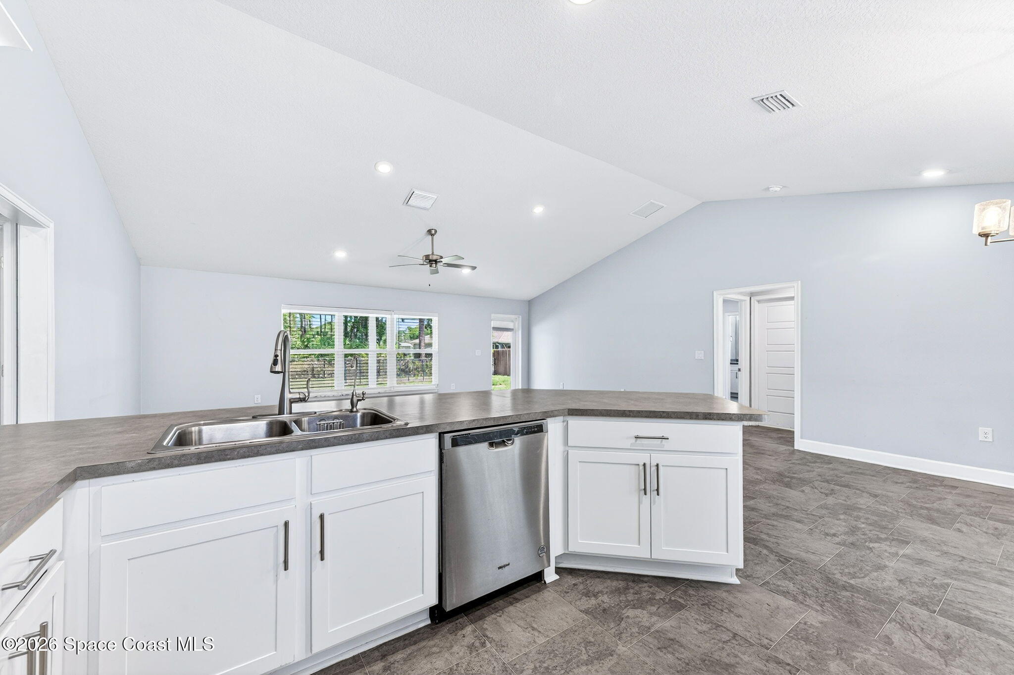717 Gelaso Street Southwest Palm Bay, FL 32908 - Photo 16 of 48 a kitchen with a sink stove and cabinets