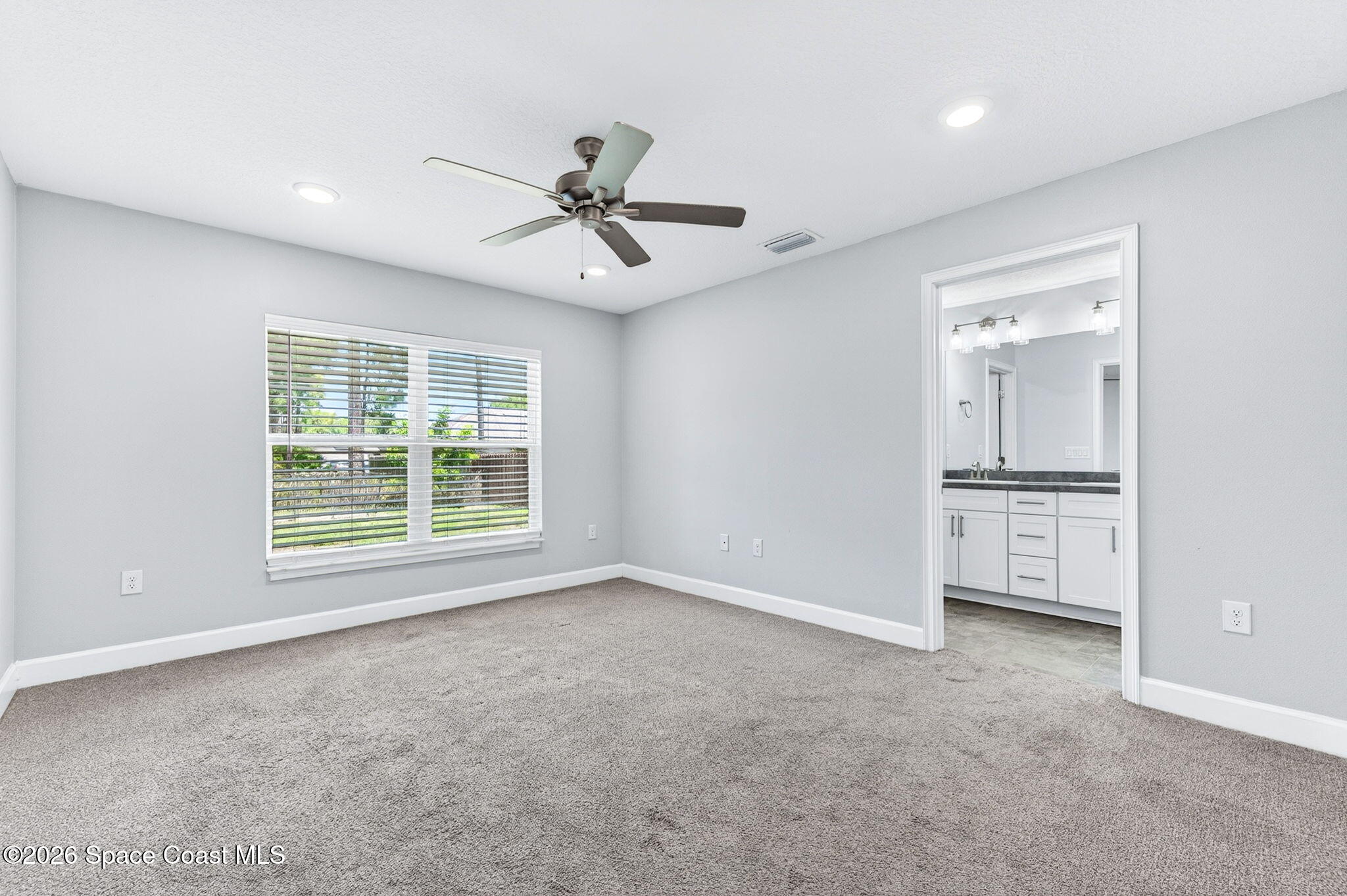 717 Gelaso Street Southwest Palm Bay, FL 32908 - Photo 21 of 48 a view of empty room with windows and cabinet