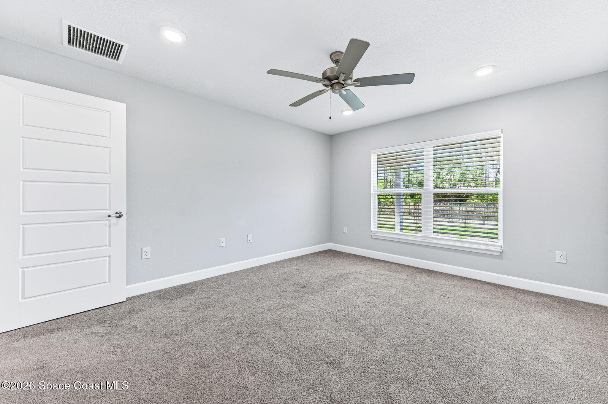 717 Gelaso Street Southwest Palm Bay, FL 32908 - Photo 23 of 48 a view of a livingroom with a ceiling fan and window