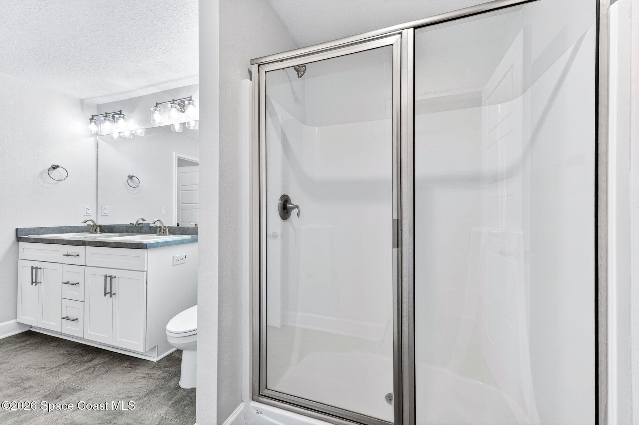 717 Gelaso Street Southwest Palm Bay, FL 32908 - Photo 25 of 48 a bathroom with a granite countertop sink a mirror and a shower