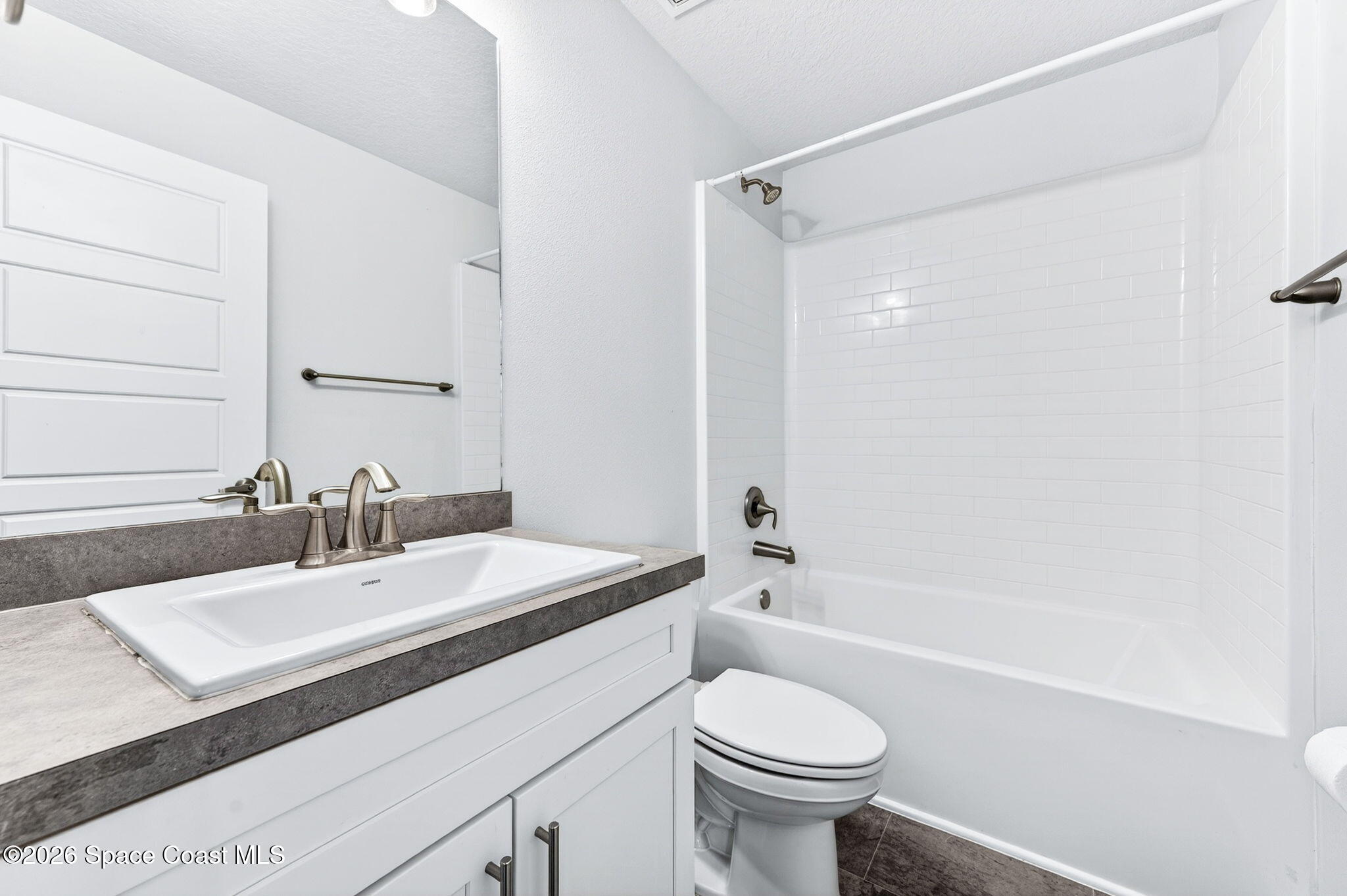 717 Gelaso Street Southwest Palm Bay, FL 32908 - Photo 29 of 48 a bathroom with a sink a toilet and shower