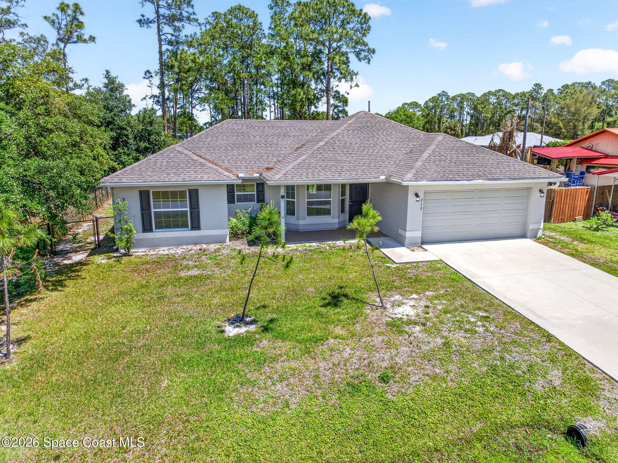 717 Gelaso Street Southwest Palm Bay, FL 32908 - Photo 37 of 48 a view of a house with a yard and potted plants