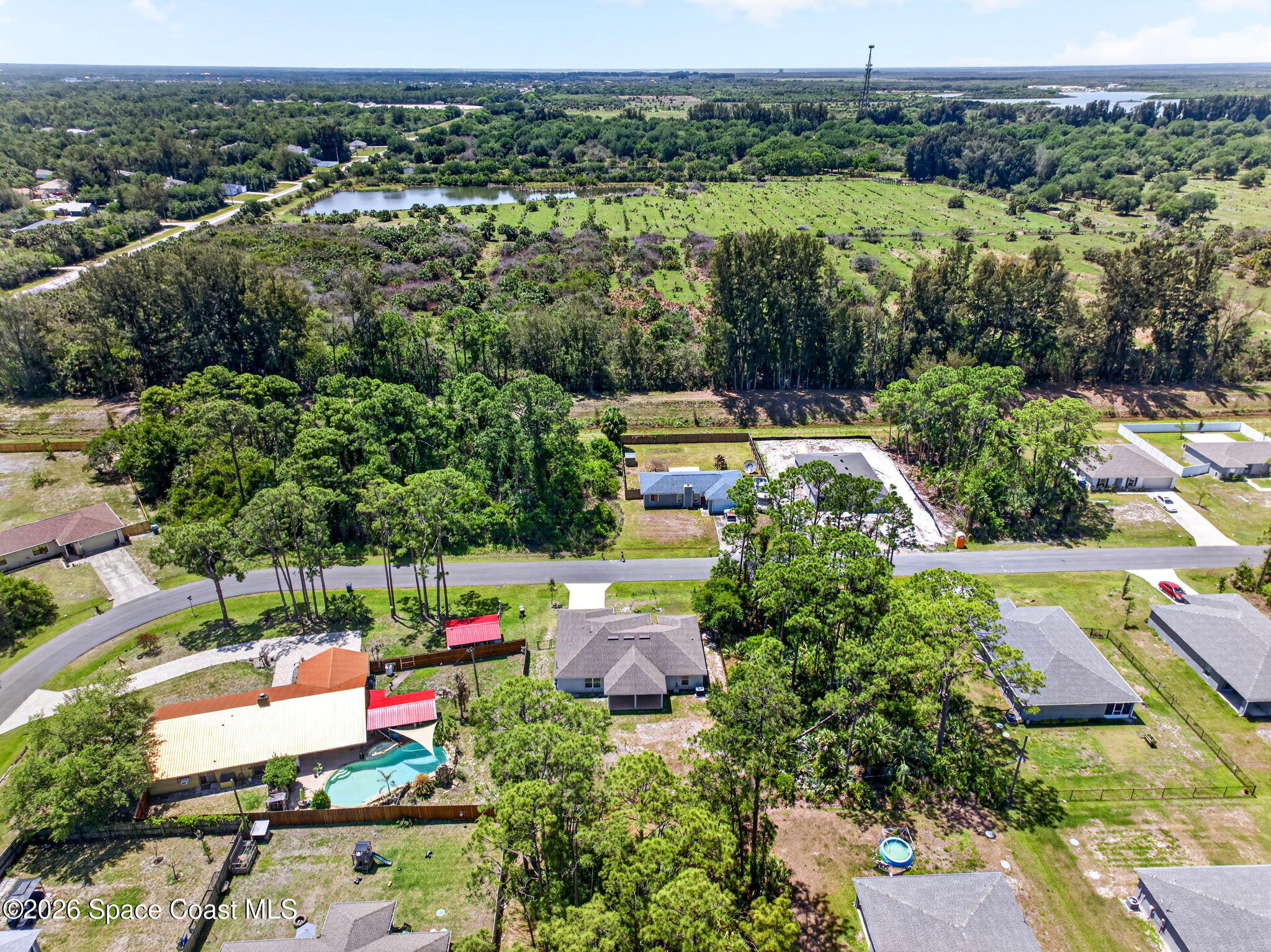 717 Gelaso Street Southwest Palm Bay, FL 32908 - Photo 46 of 48 an aerial view of a houses with a yard and lake view