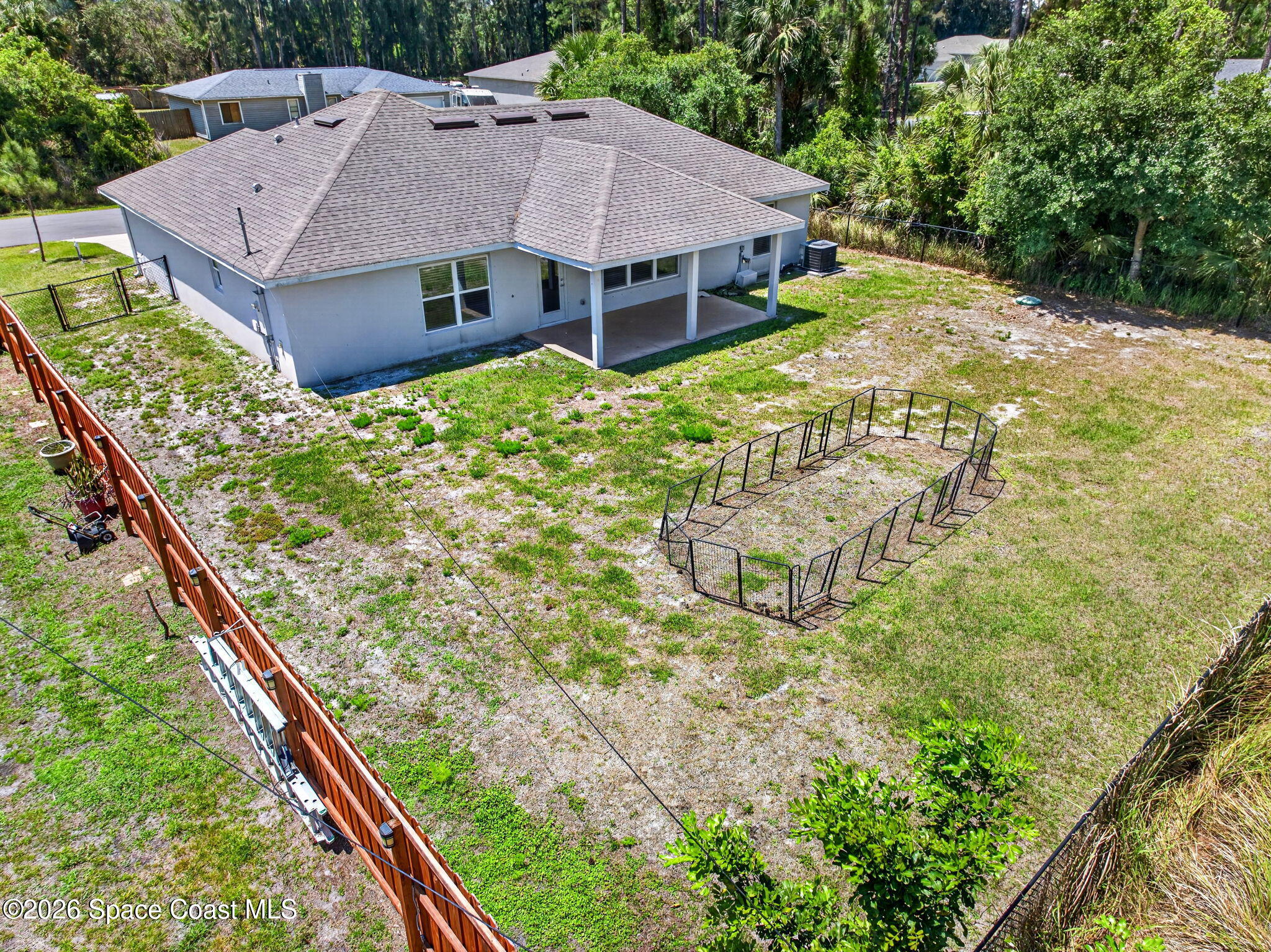 717 Gelaso Street Southwest Palm Bay, FL 32908 - Photo 5 of 48 a aerial view of a house with a yard and plants