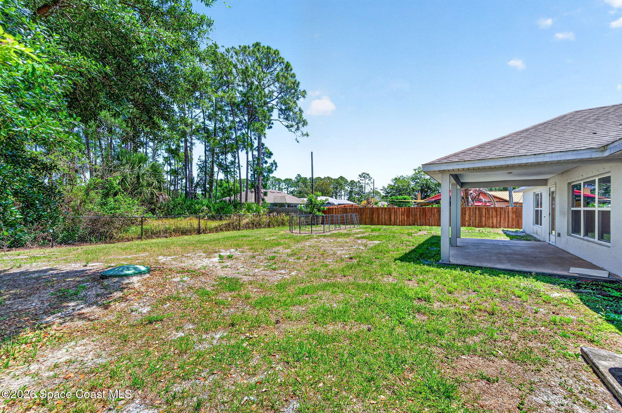 717 Gelaso Street Southwest Palm Bay, FL 32908 - Photo 8 of 48 a view of a house with a yard