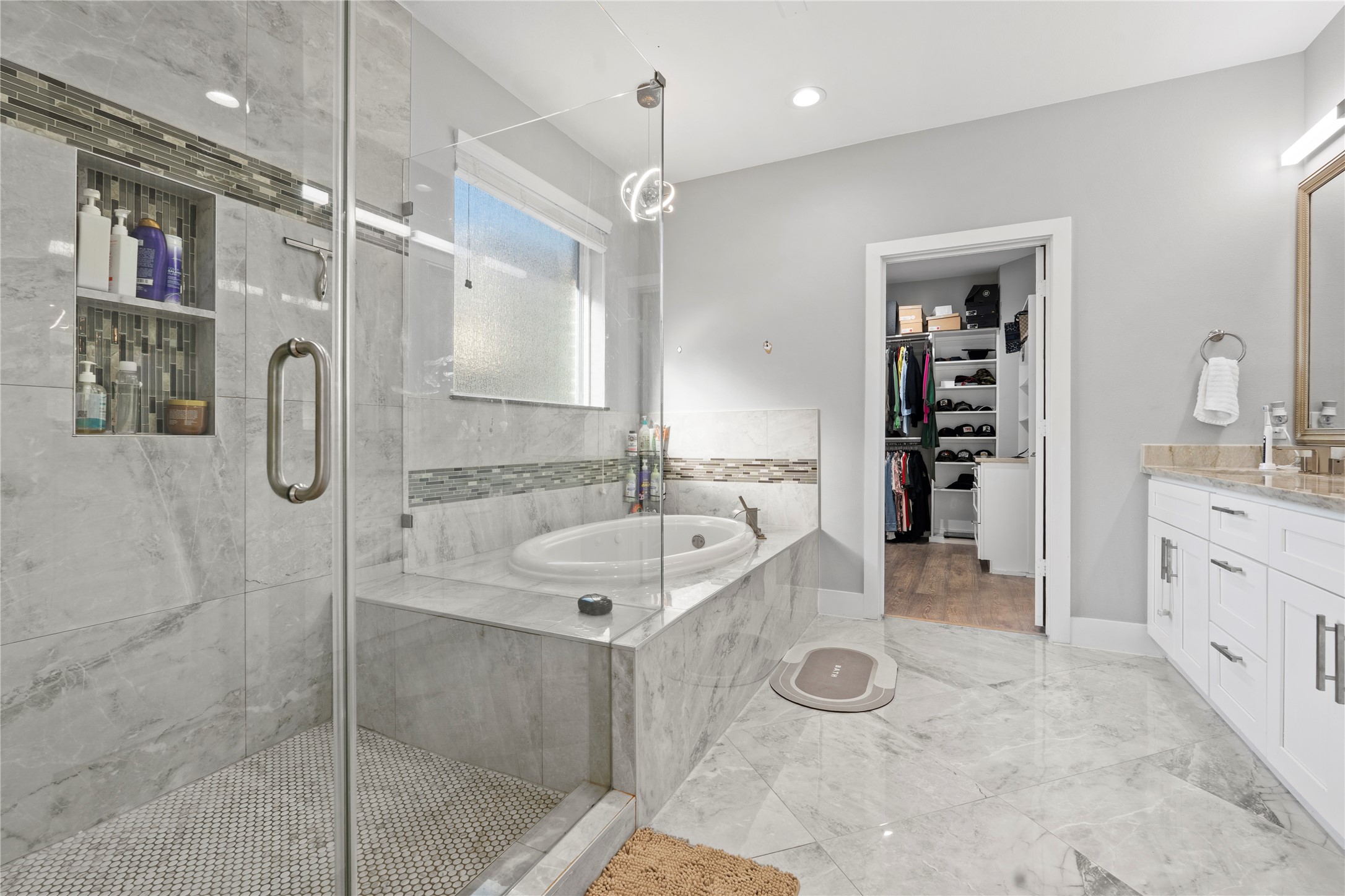 6207 Graff Net Court Spring, TX 77379 - Photo 7 of 49 Luxurious primary bathroom with a soaking jetted tub, separate shower, and tiled floors.