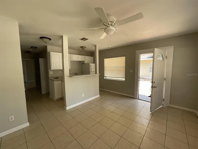 a view of a room with a fireplace and a chandelier