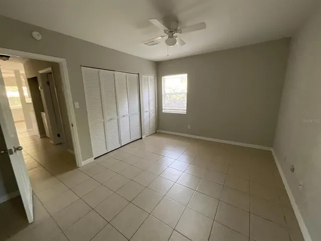 a view of an empty room and closet area