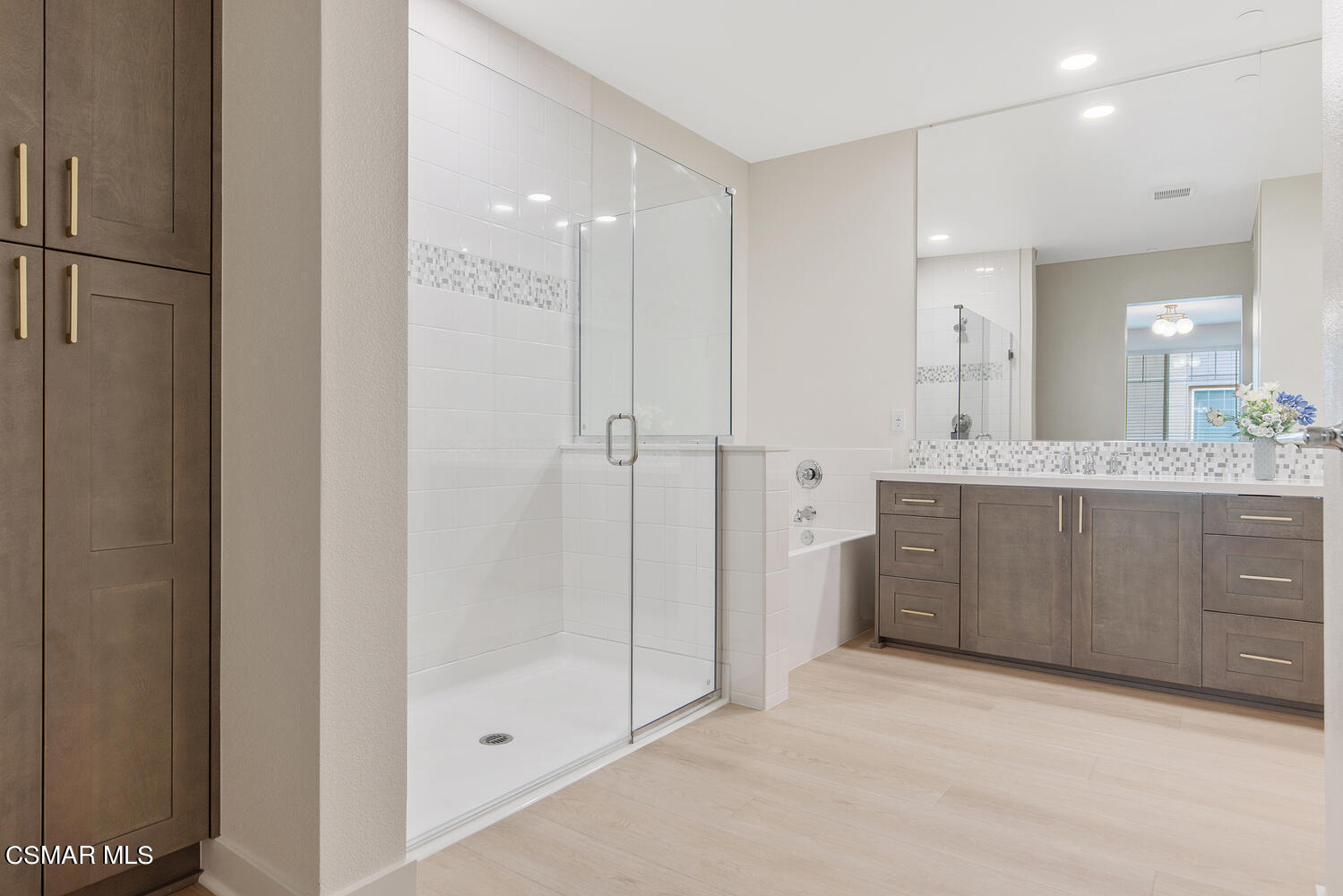 2850 Wagon Wheel Road, Unit 303 Oxnard, CA 93036 - Photo 19 of 42 a bathroom with a granite countertop sink mirror and shower