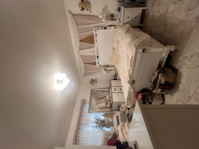 102-01 Strong Avenue Queens, NY 11368 - Photo 7 of 10 a bedroom with a bed and wooden floor