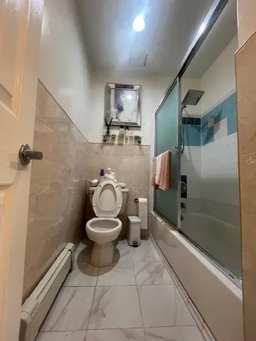 a bathroom with a toilet and a shower