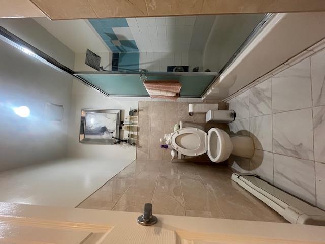 102-01 Strong Avenue Queens, NY 11368 - Photo 8 of 10 a bathroom with a toilet and a shower