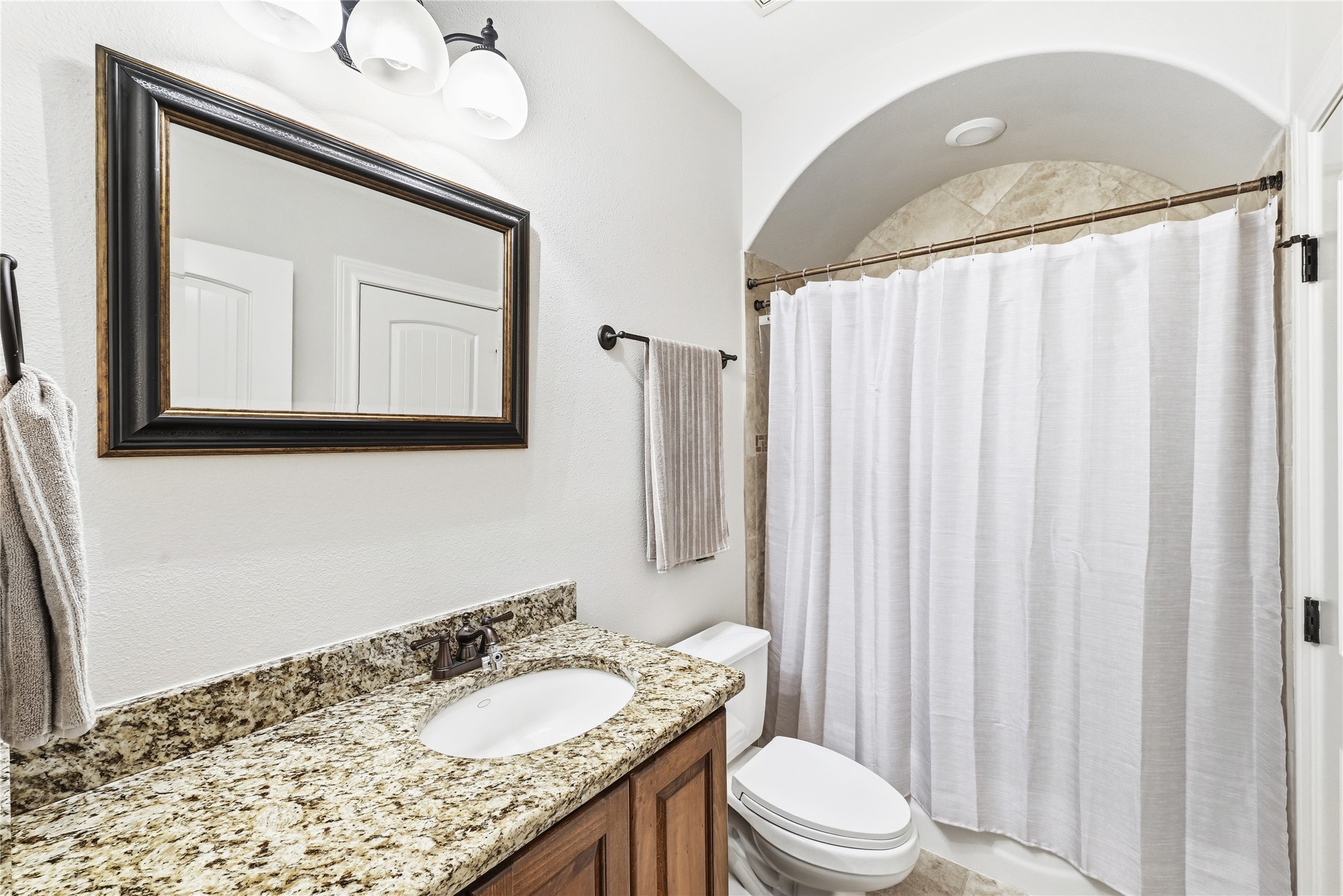 140 Winchester Road Bastrop, TX 78602 - Photo 30 of 35 Spare Bathroom attached to en-suite bedroom 3 featuring vanity and shower / bathtub combination