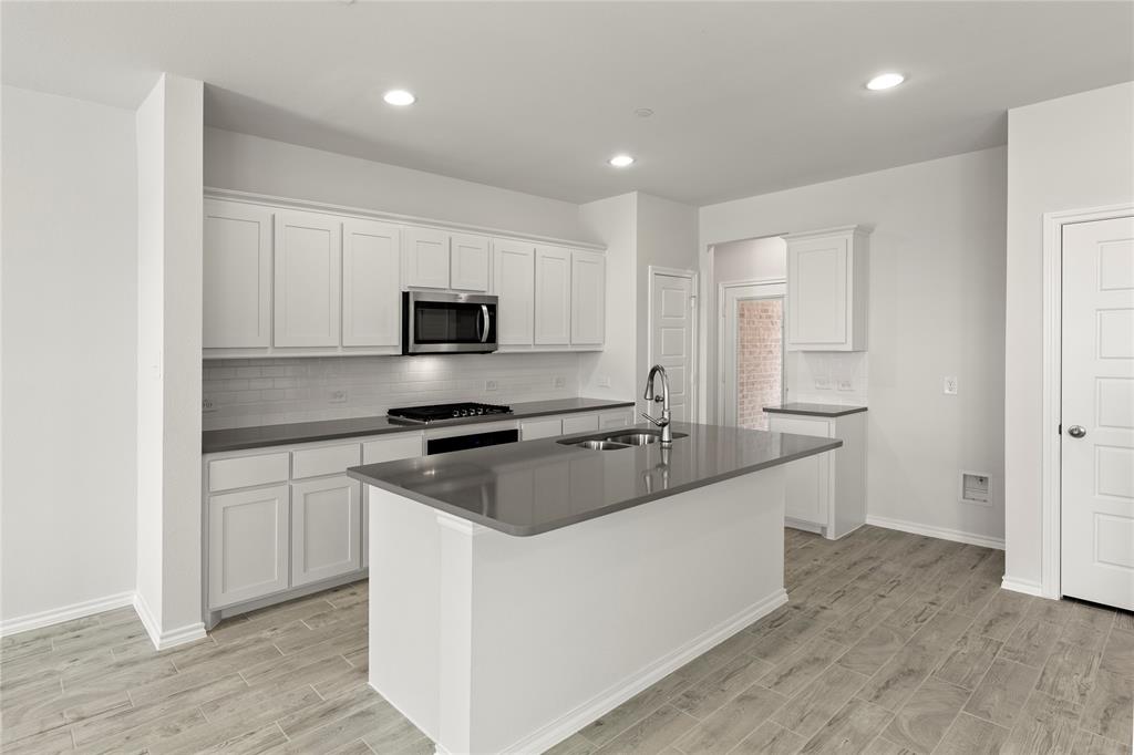 5414 East Runnel Road Royse City, TX 75189 - Photo 11 of 26 a kitchen with stainless steel appliances granite countertop a sink stove and refrigerator