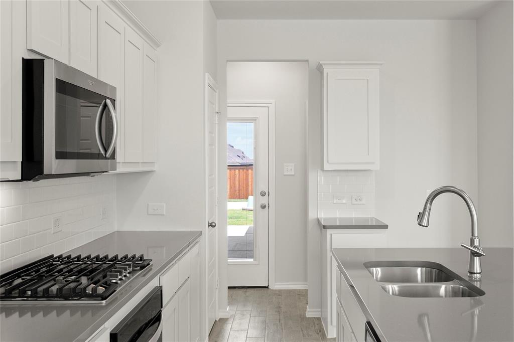 5414 East Runnel Road Royse City, TX 75189 - Photo 12 of 26 a kitchen with sink a stove and refrigerator