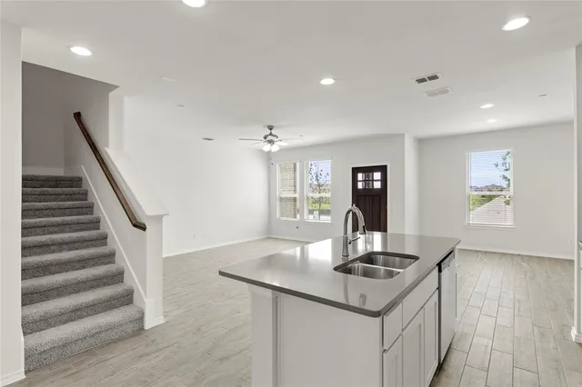 a kitchen with granite countertop a stove and a sink