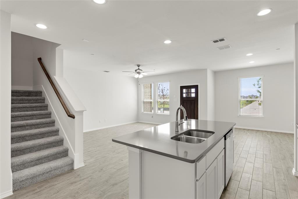 5414 East Runnel Road Royse City, TX 75189 - Photo 13 of 26 a kitchen with granite countertop a stove and a sink