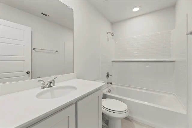 a bathroom with a sink toilet vanity and shower