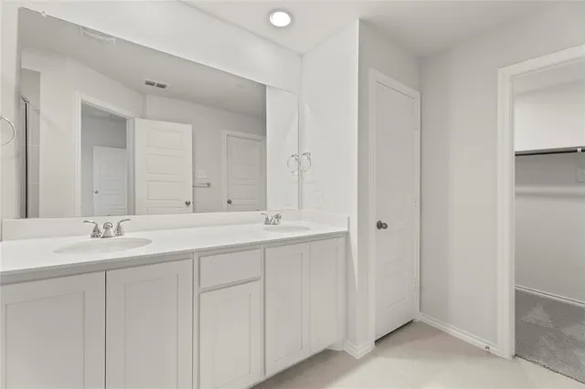 a bathroom with 2 sink and a mirror