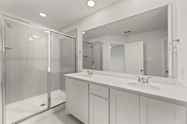 a bathroom with a shower sink and mirror