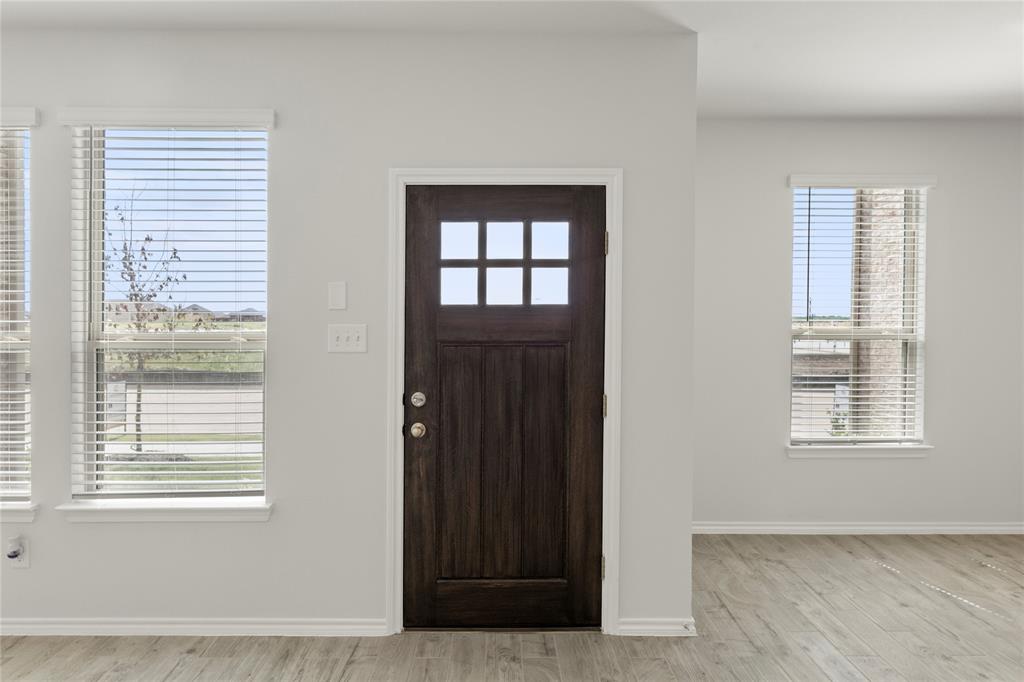 5414 East Runnel Road Royse City, TX 75189 - Photo 3 of 26 a view of an empty room with wooden floor and a window