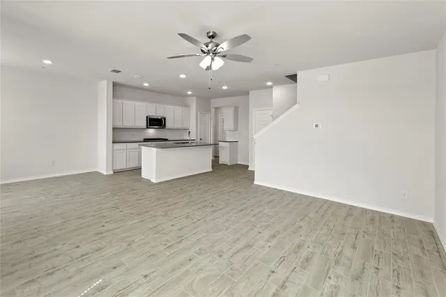 a view of a kitchen with a sink and a refrigerator