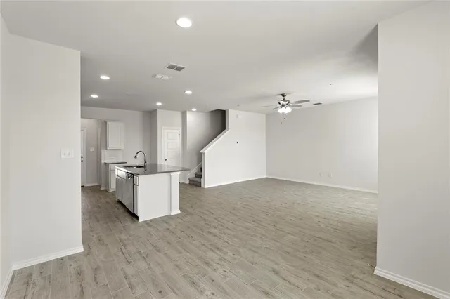 a view of kitchen and hall with wooden floor