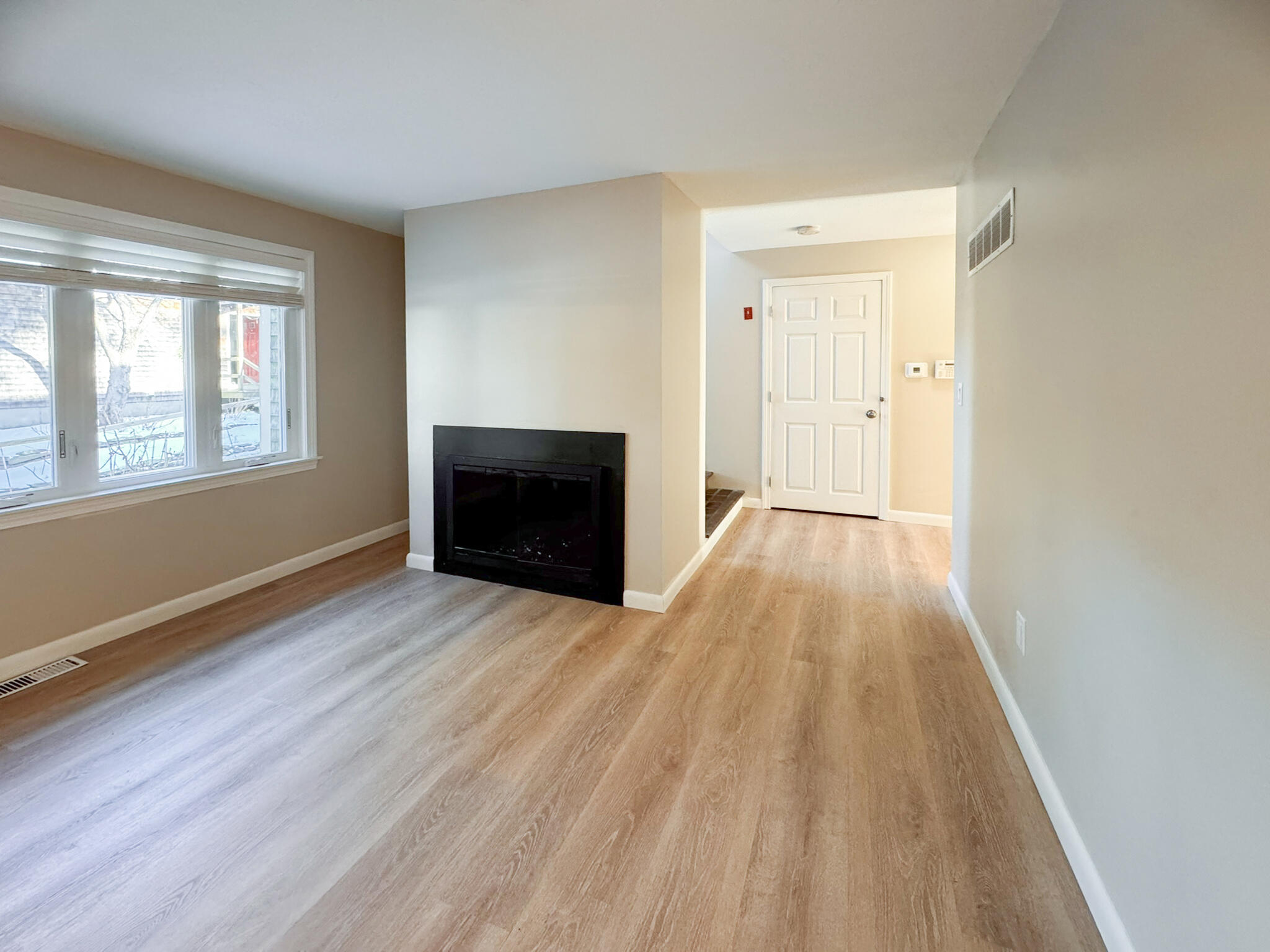 225 SW Meadows, Unit 225 Teaticket, MA 02536 - Photo 12 of 27 an empty room with wooden floor and windows
