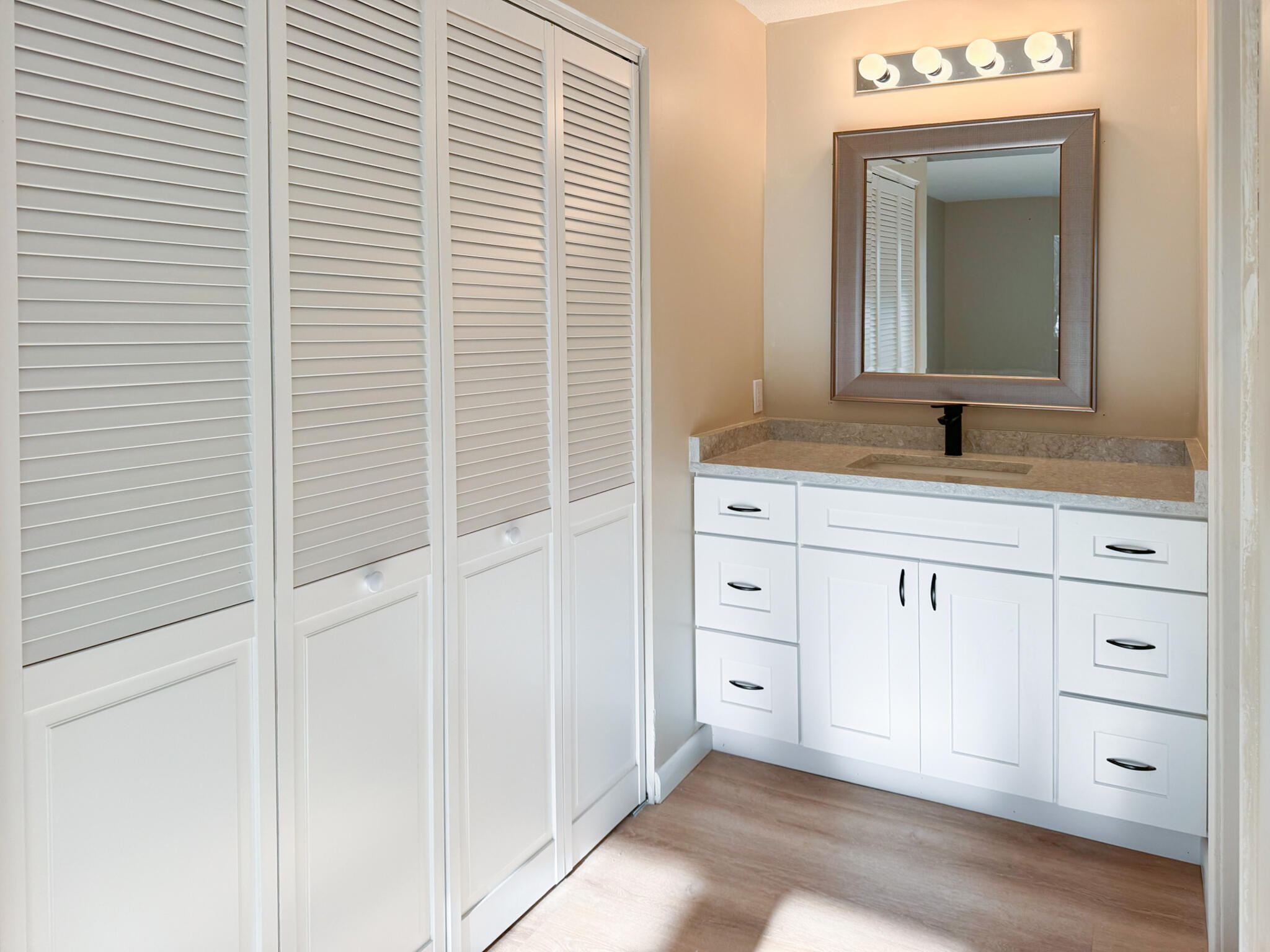225 SW Meadows, Unit 225 Teaticket, MA 02536 - Photo 22 of 27 a bathroom with a granite countertop sink and a mirror